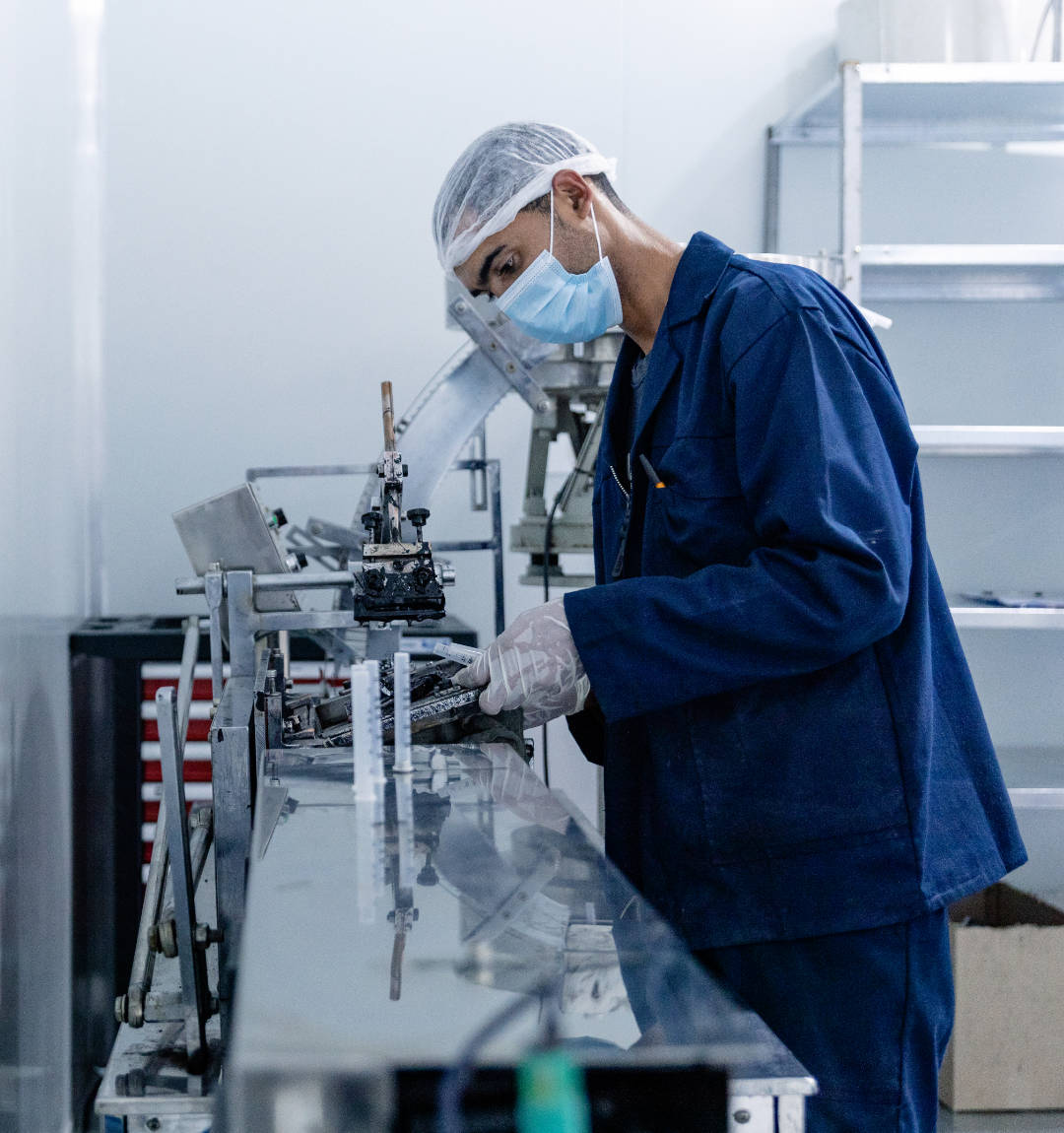 Technician assembling parts in production line